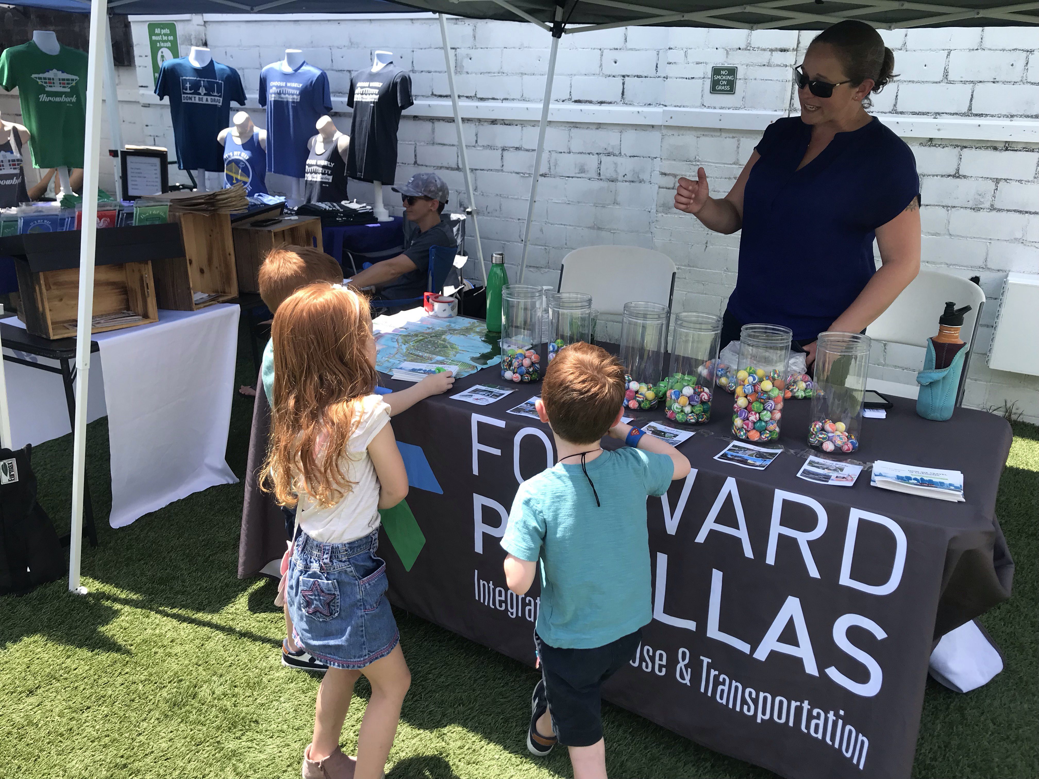 Children at a table taking the Advantage Pinellas survey with balls assigned to modes of transportation