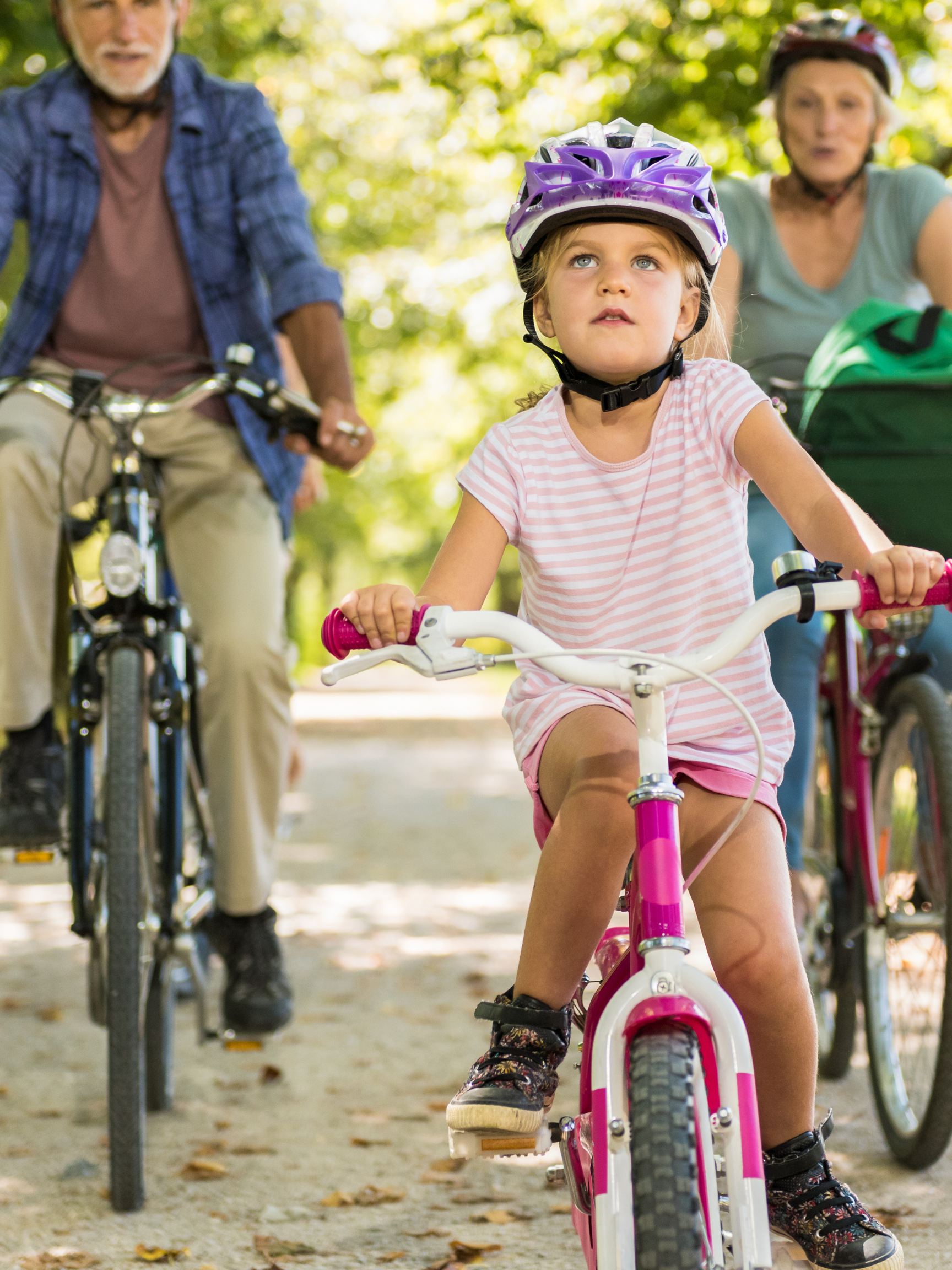 kid and grandparents on bikes