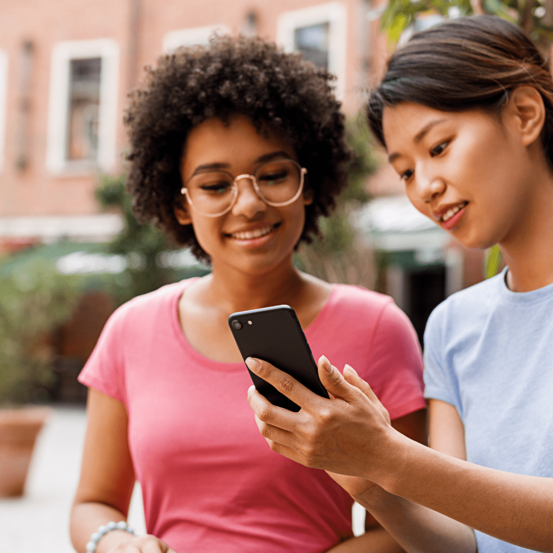 two girls looking at phone